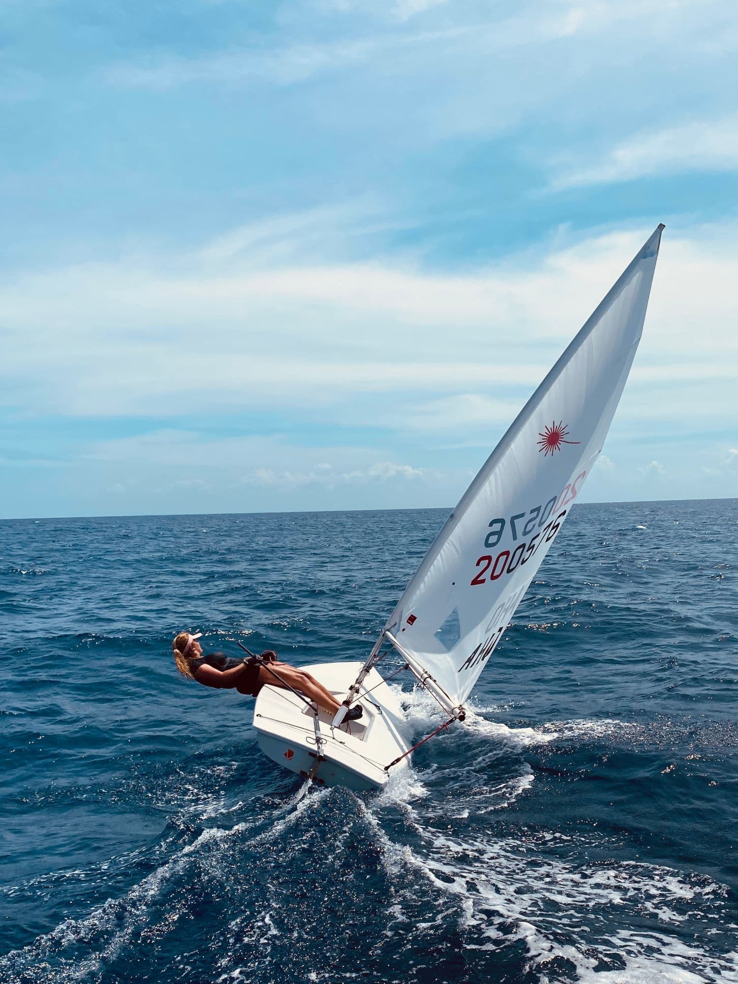 Sterre sailing a Laser dinghy at sea