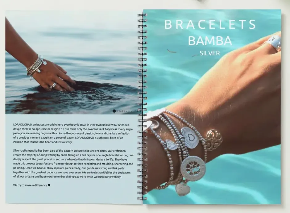 An open Lora di Lora catalogue with silver bracelets